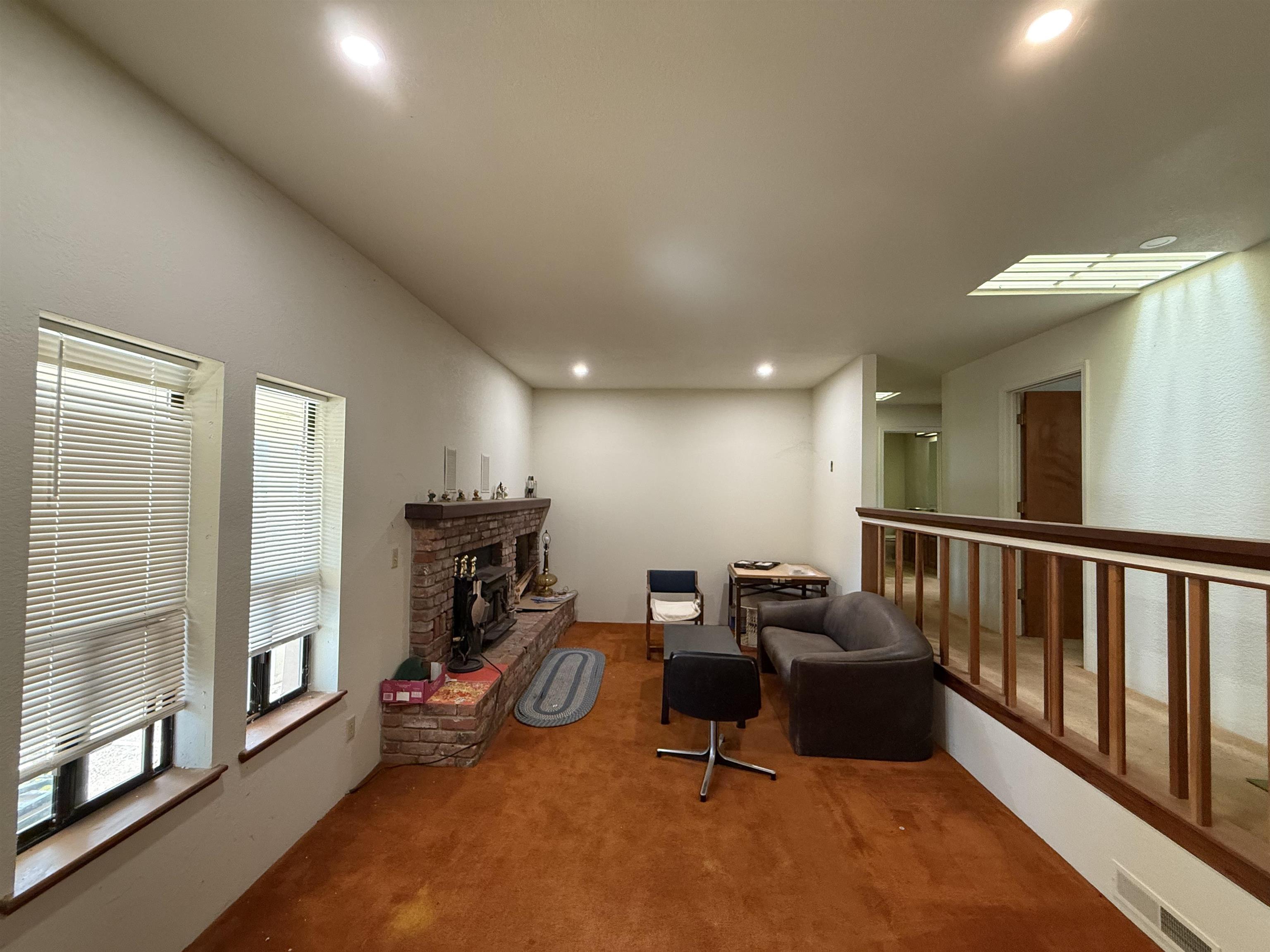 5893 Fruitland Road Marysville, CA 95901 - Photo 12 of 35 a room with furniture a flat screen tv and a window