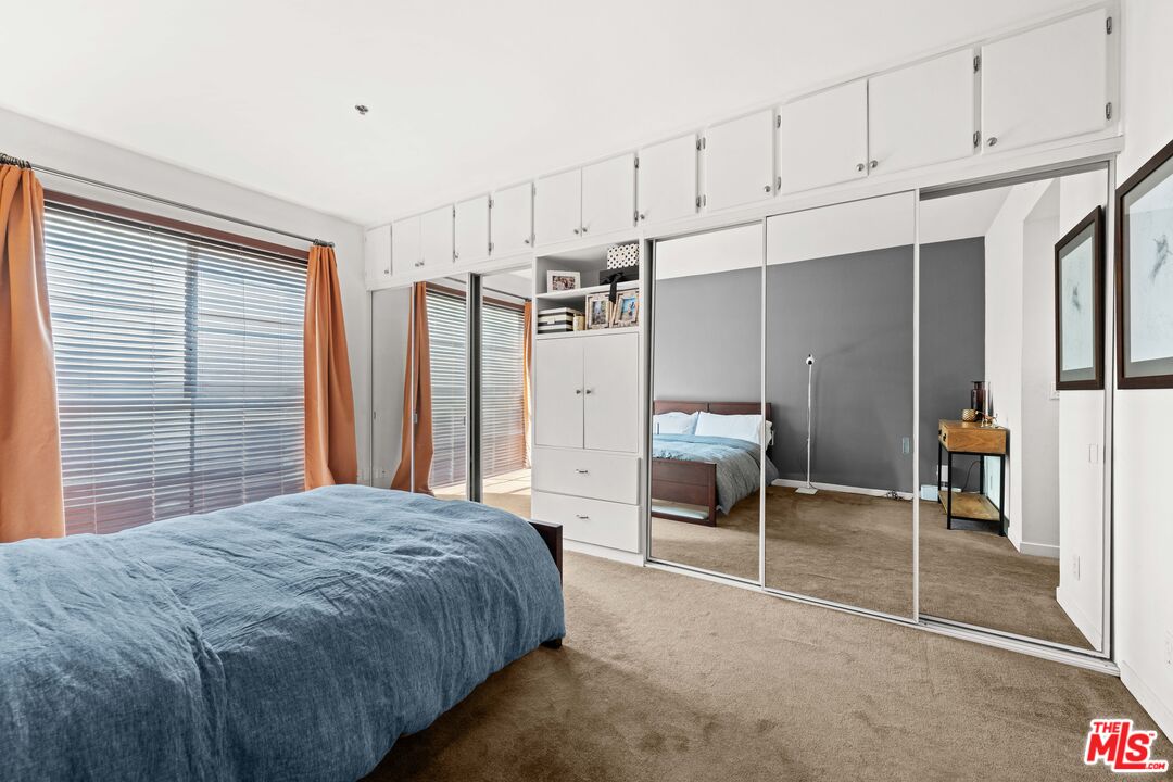 1401 South Bentley Avenue, Unit 202 Los Angeles, CA 90025 - Photo 12 of 32 a spacious bedroom with a bed and a cabinets
