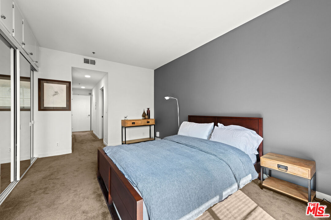 1401 South Bentley Avenue, Unit 202 Los Angeles, CA 90025 - Photo 13 of 32 a bedroom with a bed and a lamp