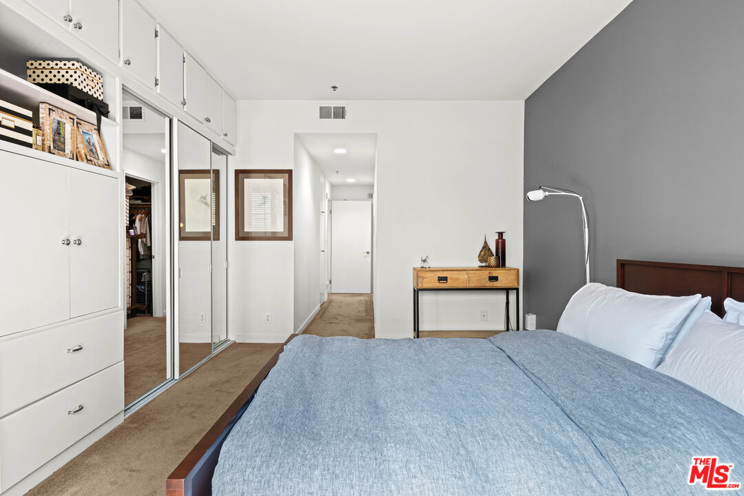 1401 South Bentley Avenue, Unit 202 Los Angeles, CA 90025 - Photo 14 of 32 a bedroom with a bed and a table