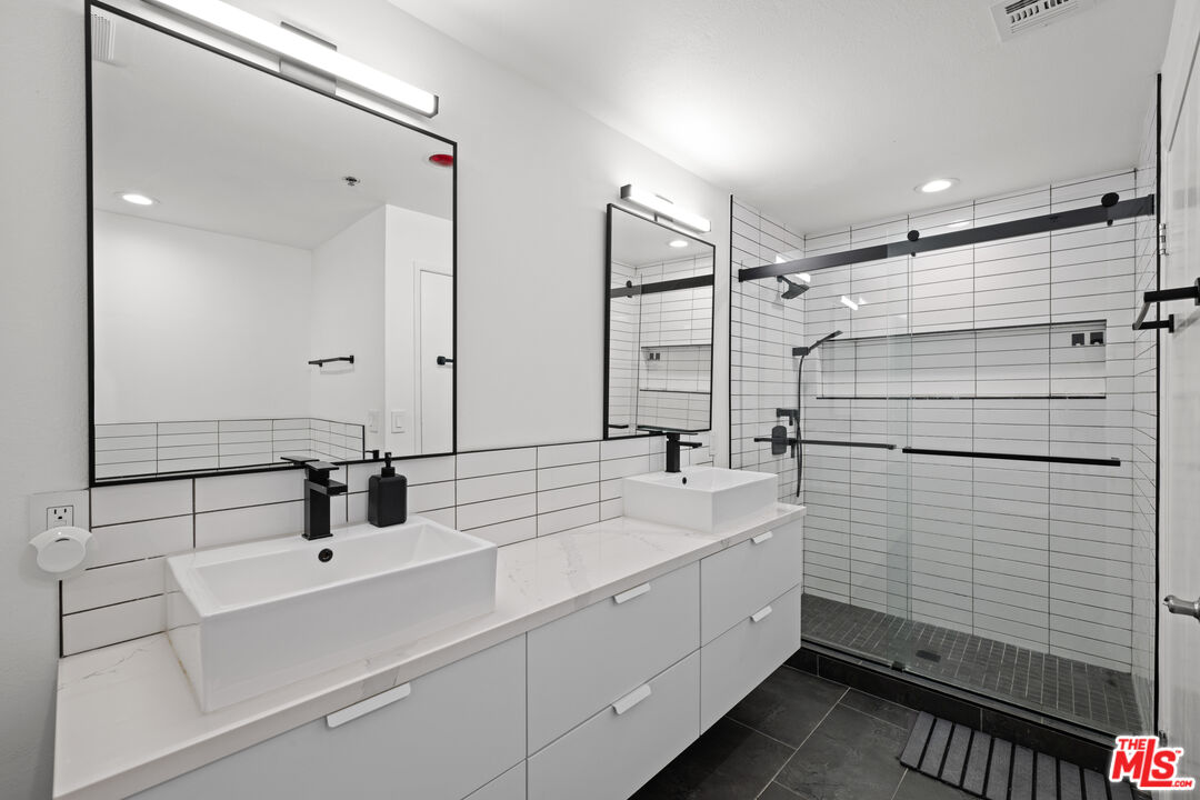 1401 South Bentley Avenue, Unit 202 Los Angeles, CA 90025 - Photo 15 of 32 a bathroom with a sink and mirror