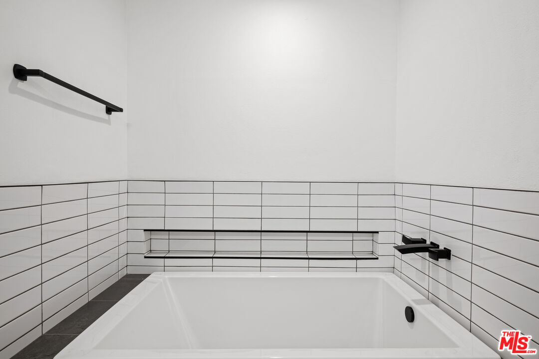 1401 South Bentley Avenue, Unit 202 Los Angeles, CA 90025 - Photo 17 of 32 a bathroom with a bathtub and shower