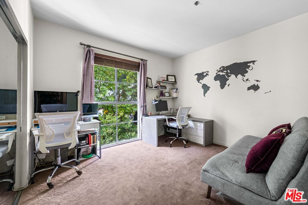 1401 South Bentley Avenue, Unit 202 Los Angeles, CA 90025 - Photo 18 of 32 a living room with furniture a window and a flat screen tv