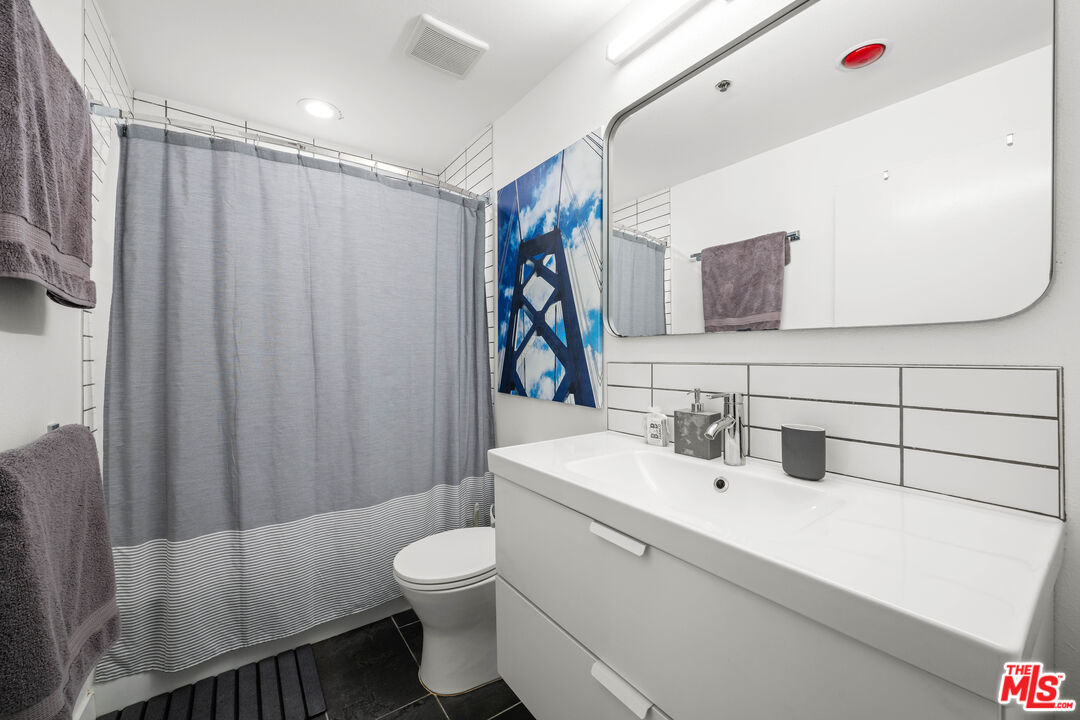 1401 South Bentley Avenue, Unit 202 Los Angeles, CA 90025 - Photo 21 of 32 a bathroom with a sink toilet and shower
