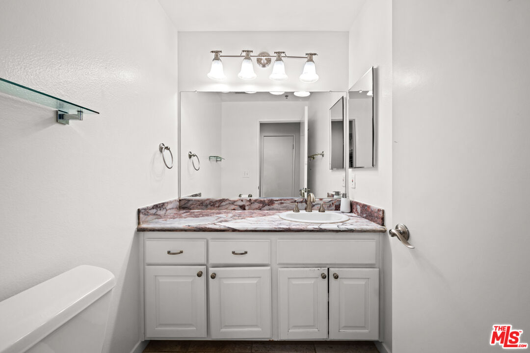 1401 South Bentley Avenue, Unit 202 Los Angeles, CA 90025 - Photo 22 of 32 a bathroom with a sink and a mirror