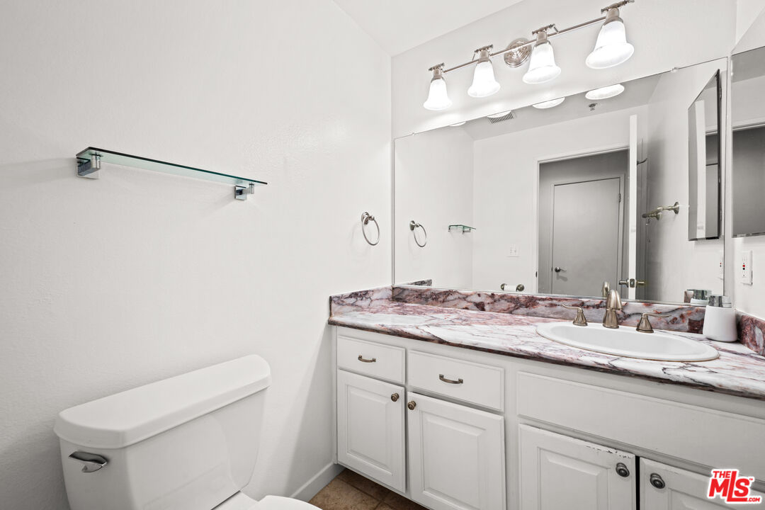 1401 South Bentley Avenue, Unit 202 Los Angeles, CA 90025 - Photo 23 of 32 a bathroom with a sink vanity granite and toilet