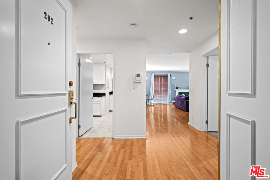 1401 South Bentley Avenue, Unit 202 Los Angeles, CA 90025 - Photo 24 of 32 a view of a hallway with wooden floor and a bathroom