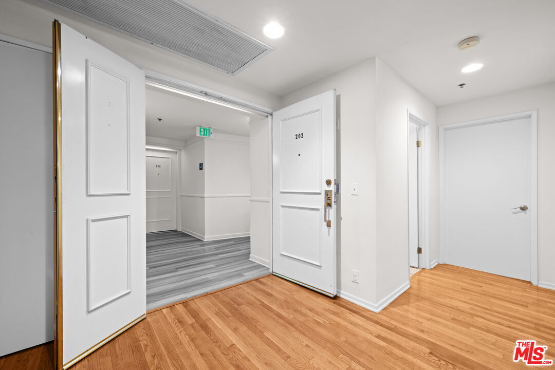 1401 South Bentley Avenue, Unit 202 Los Angeles, CA 90025 - Photo 25 of 32 a view of a livingroom with wooden floor