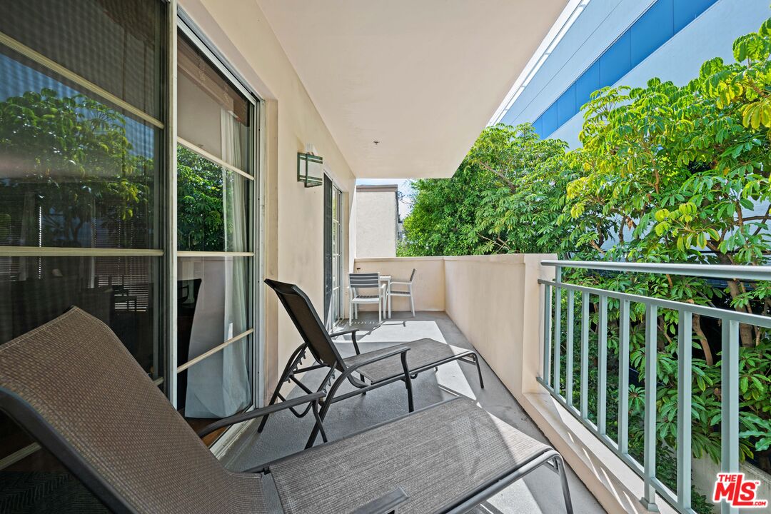 1401 South Bentley Avenue, Unit 202 Los Angeles, CA 90025 - Photo 26 of 32 a view of a balcony with chair and wooden floor