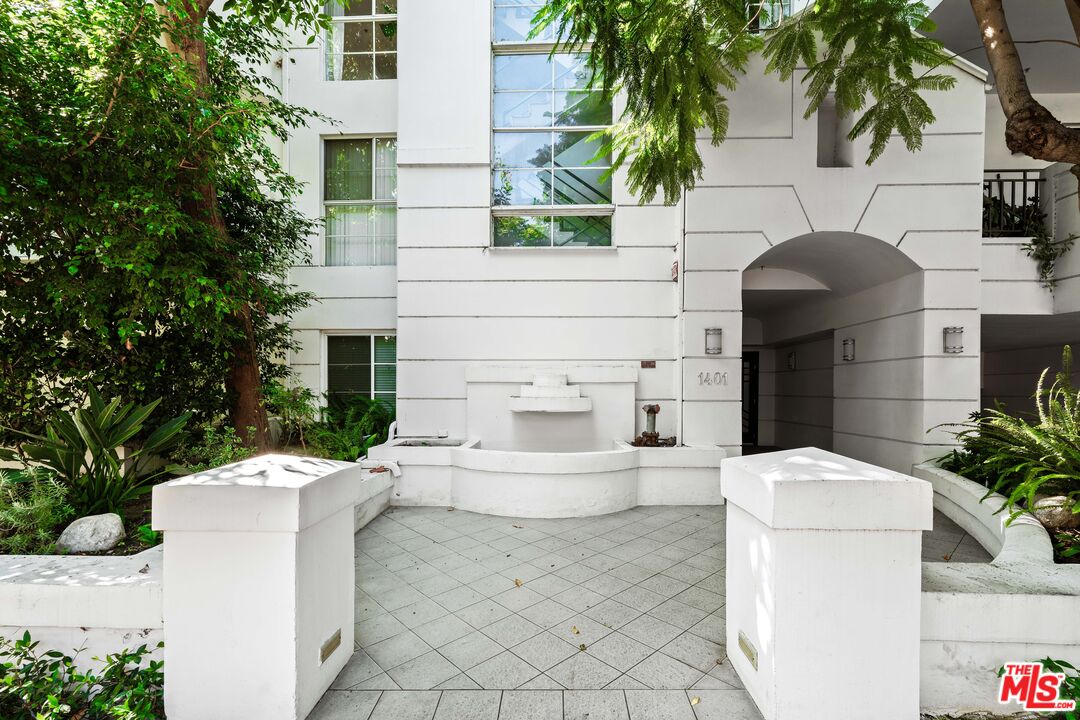 1401 South Bentley Avenue, Unit 202 Los Angeles, CA 90025 - Photo 30 of 32 a view of a white house with a sink and potted plants
