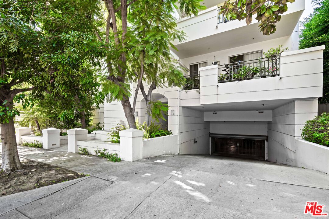 1401 South Bentley Avenue, Unit 202 Los Angeles, CA 90025 - Photo 31 of 32 a front view of a house with a garage