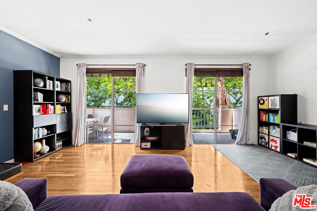 1401 South Bentley Avenue, Unit 202 Los Angeles, CA 90025 - Photo 5 of 32 a living room with furniture and a flat screen tv