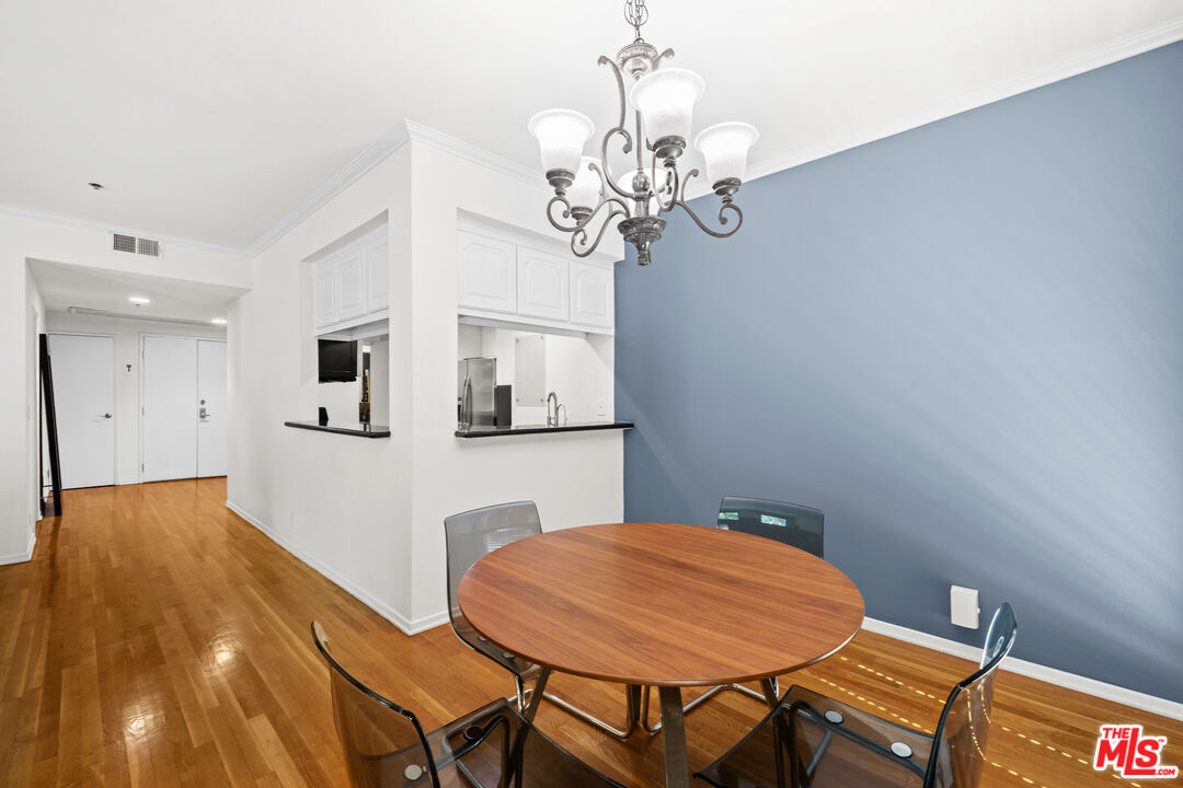 1401 South Bentley Avenue, Unit 202 Los Angeles, CA 90025 - Photo 9 of 32 a dining room with a table and chairs