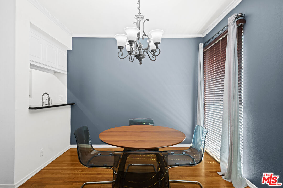 1401 South Bentley Avenue, Unit 202 Los Angeles, CA 90025 - Photo 10 of 32 a view of a dining room with furniture wooden floor and a chandelier