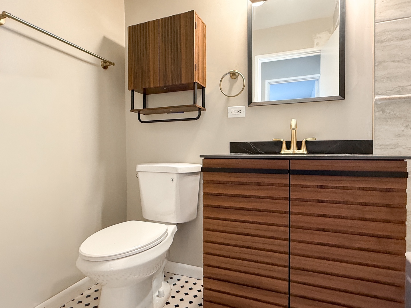 9724 Bianco Terrace, Unit A Des Plaines, IL 60016 - Photo 11 of 13 a bathroom with a sink a toilet and mirror