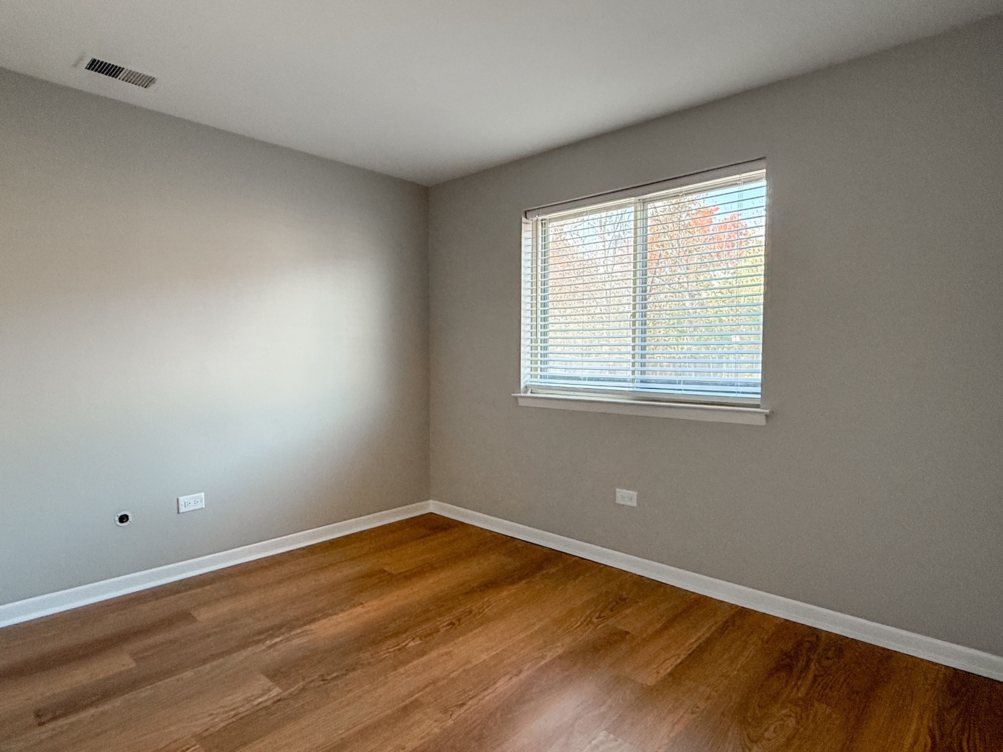 9724 Bianco Terrace, Unit A Des Plaines, IL 60016 - Photo 9 of 13 a view of a room with wooden floor and windows