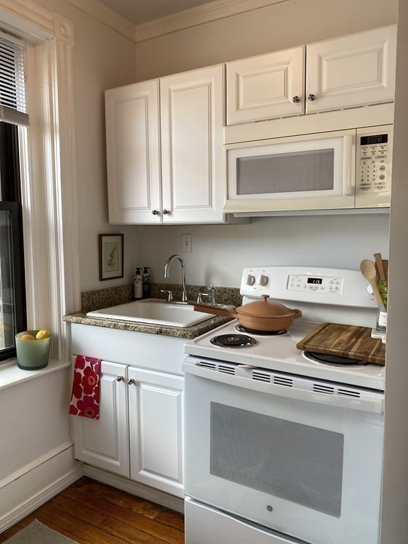 552 Tremont Street, Unit 2F Boston, MA 02118 - Photo 3 of 5 a kitchen with stainless steel appliances granite countertop a stove and a refrigerator