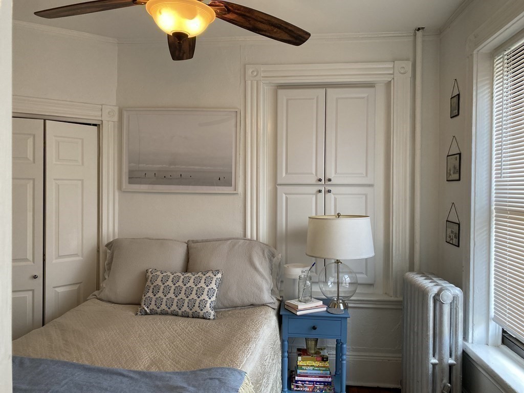 552 Tremont Street, Unit 2F Boston, MA 02118 - Photo 4 of 5 a bedroom with a bed and wooden floor