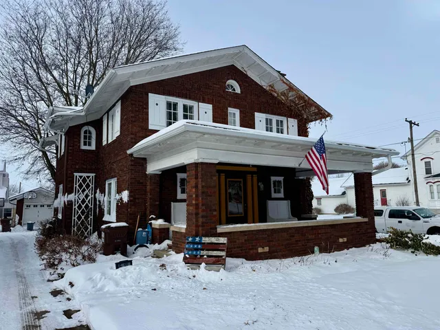 a view of a house with a yard and sitting area
