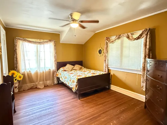 a bedroom with a bed cabinet and a window