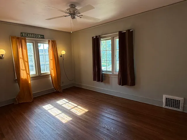 a view of a room with furniture and window