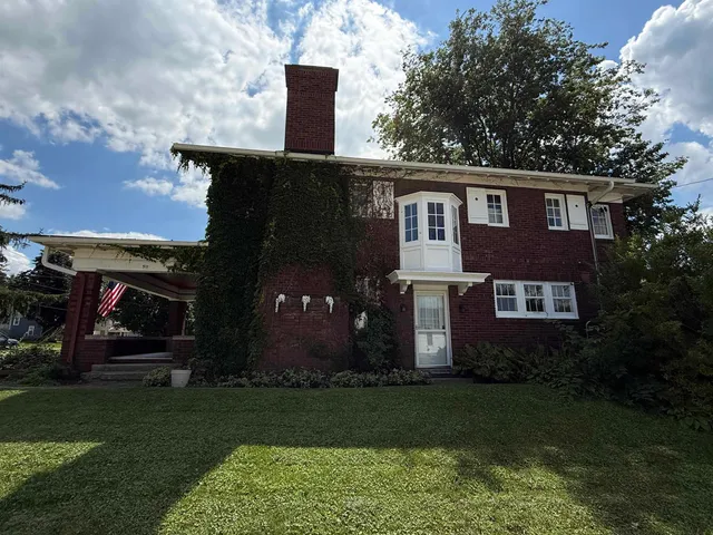 a front view of a house with a garden