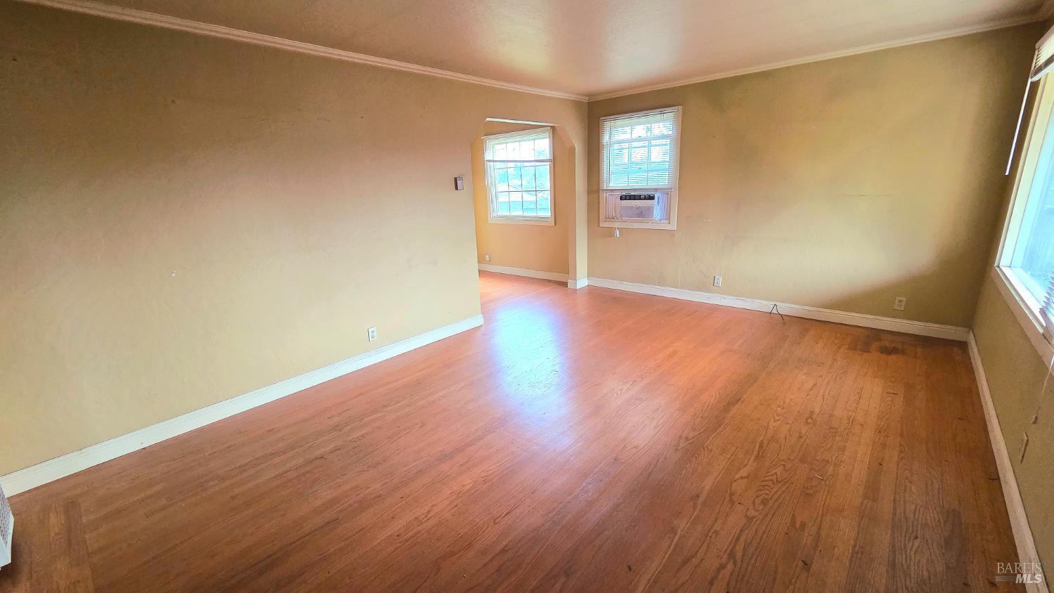 1420 Fulton Road Santa Rosa, CA 95403 - Photo 4 of 17 an empty room with wooden floor and windows