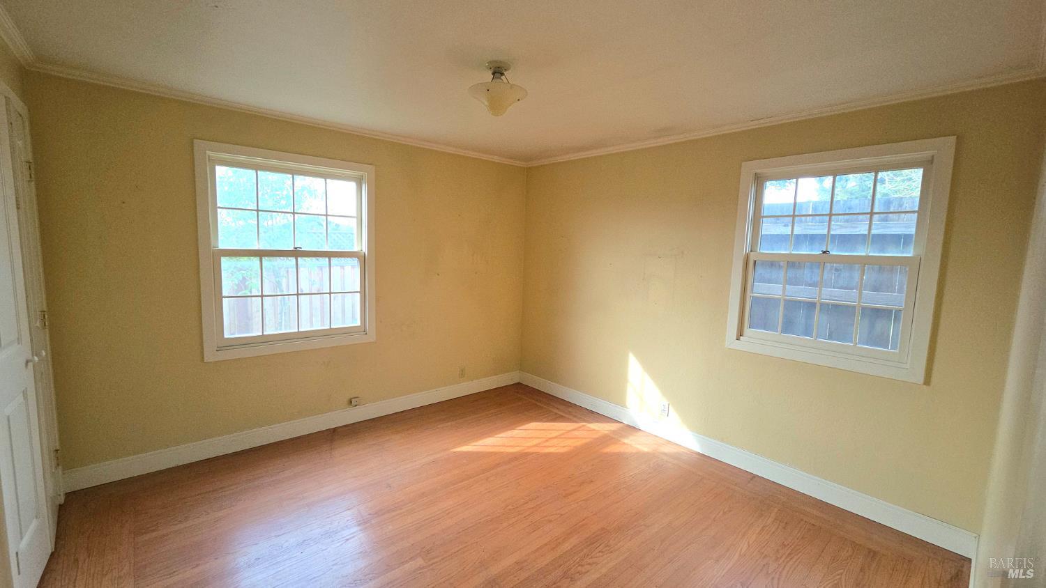 1420 Fulton Road Santa Rosa, CA 95403 - Photo 9 of 17 a view of an empty room with wooden floor and a window