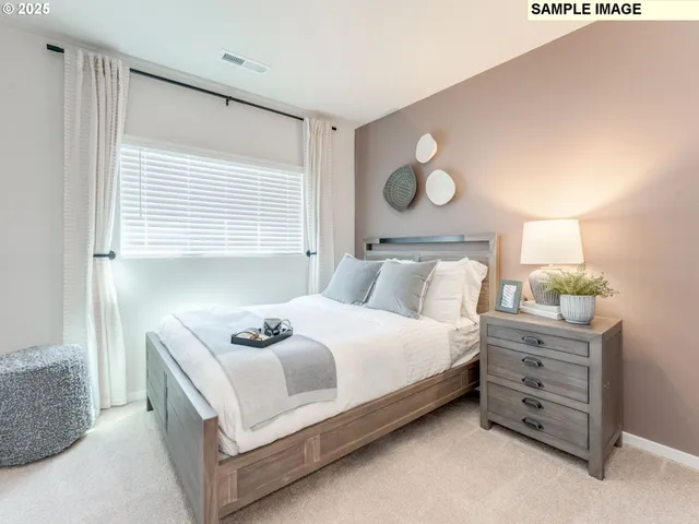 a bedroom with a bed and window