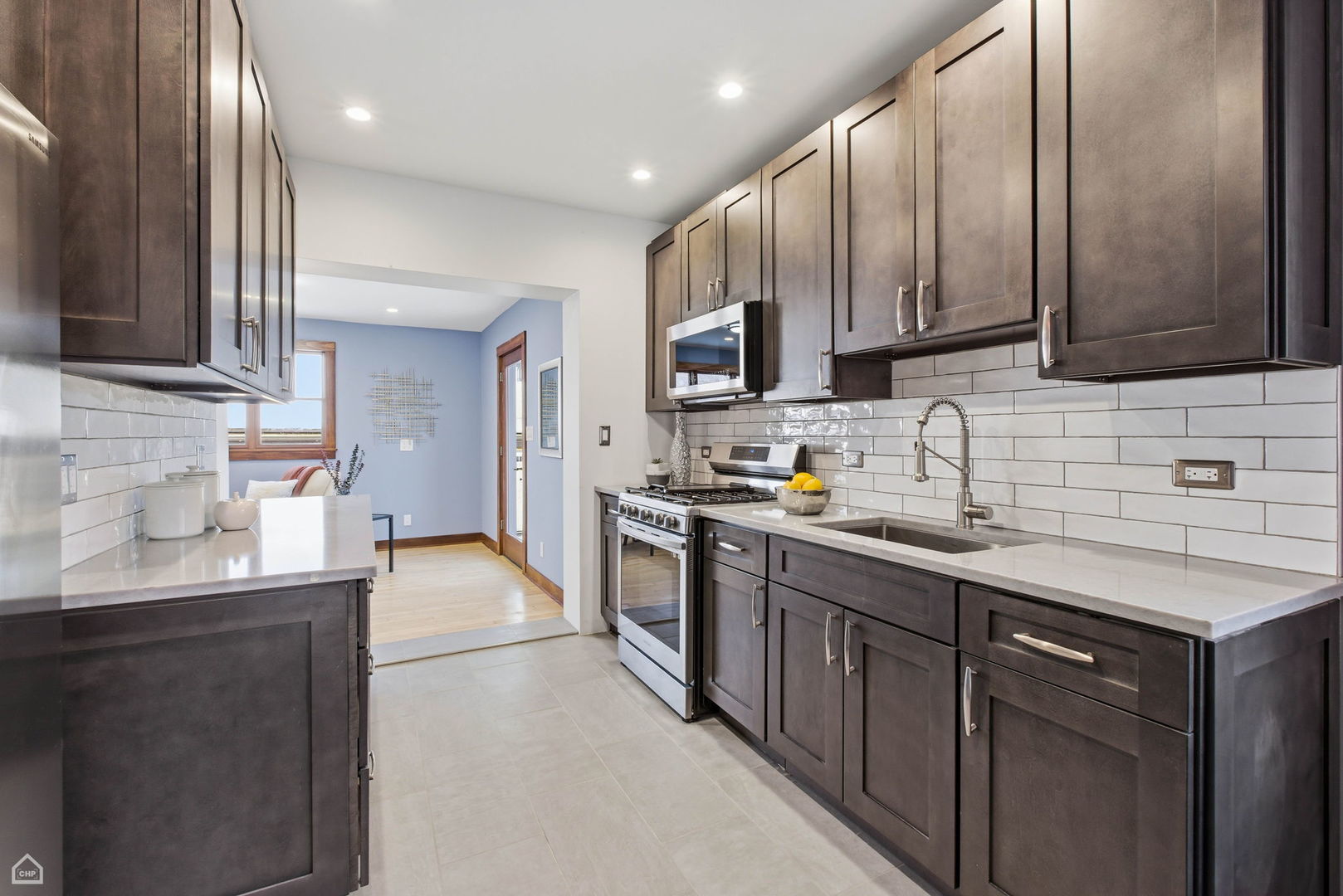 3814 North Mozart Street Chicago, IL 60618 - Photo 11 of 37 a kitchen with stainless steel appliances granite countertop a sink stove and refrigerator