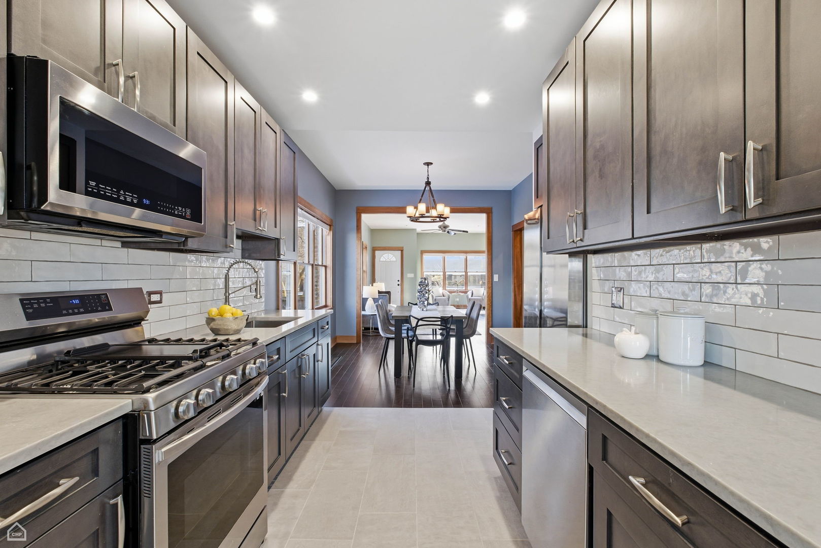 3814 North Mozart Street Chicago, IL 60618 - Photo 13 of 37 a kitchen with stainless steel appliances granite countertop a stove sink microwave and cabinets