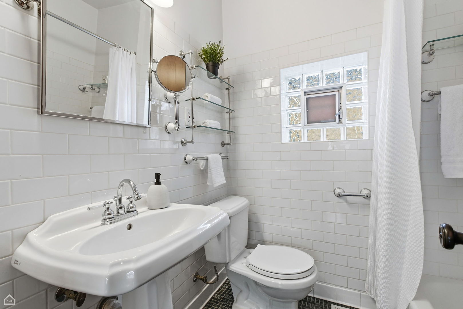 3814 North Mozart Street Chicago, IL 60618 - Photo 17 of 37 a bathroom with a sink a toilet and mirror