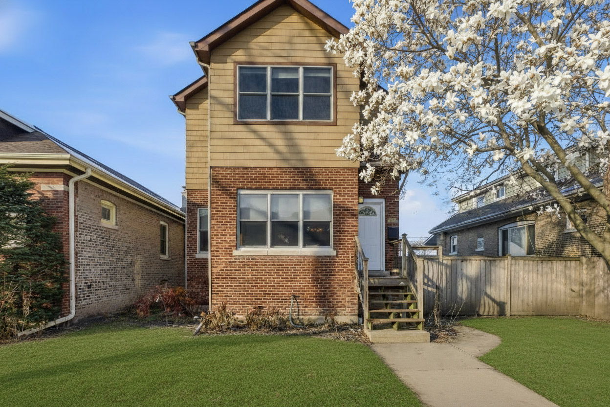 3814 North Mozart Street Chicago, IL 60618 - Photo 2 of 37 a front view of a house with a yard and garage