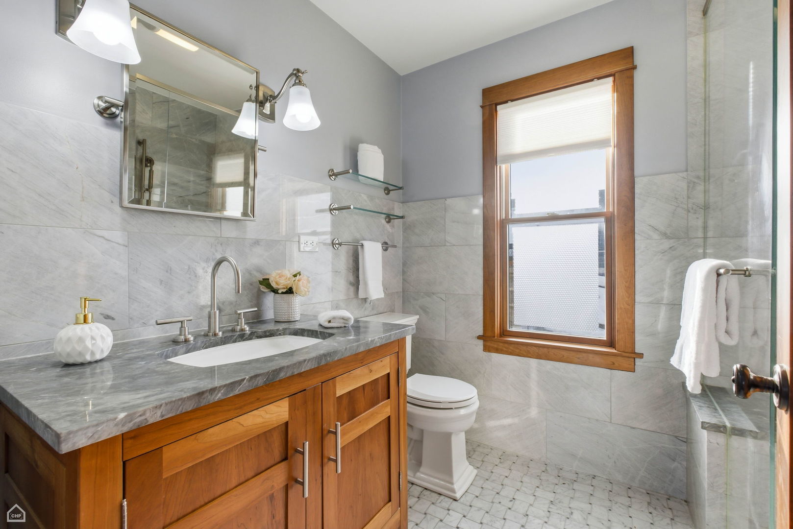 3814 North Mozart Street Chicago, IL 60618 - Photo 26 of 37 a bathroom with a granite countertop sink mirror vanity and toilet