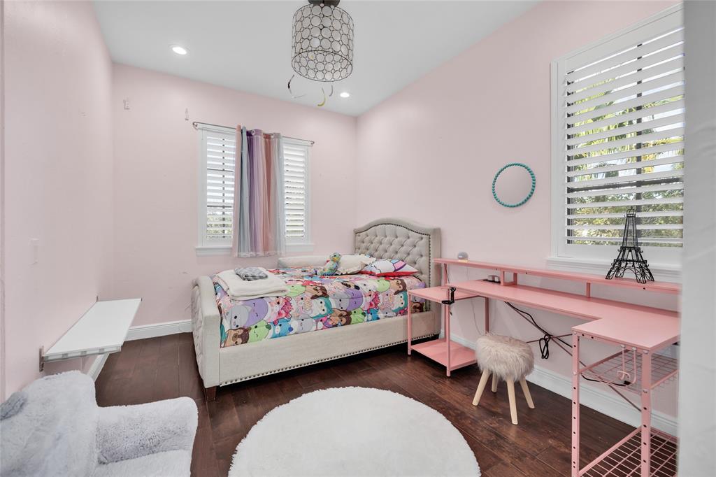 6915 Long Leaf Drive Parkland, FL 33076 - Photo 37 of 80 a bedroom with a bed and a chandelier