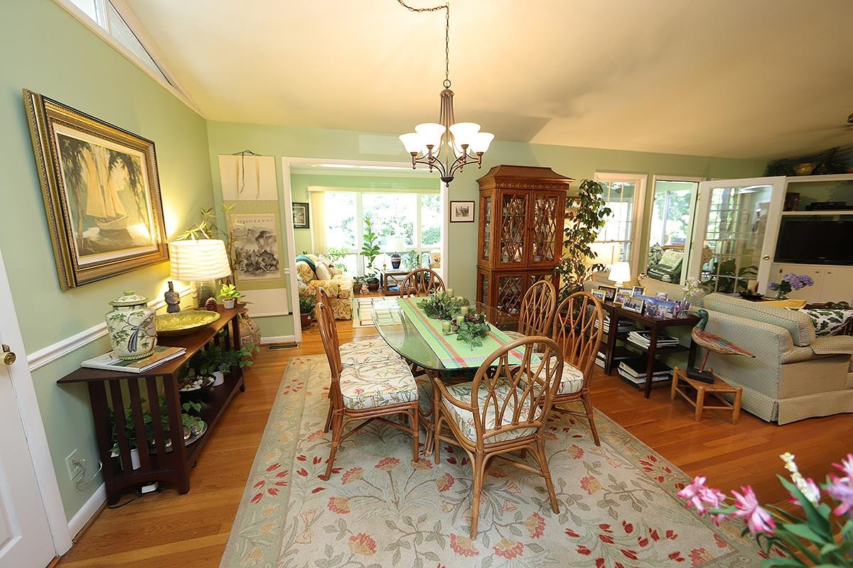 2505 Medway Drive Raleigh, NC 27608 - Photo 4 of 18 a living room with fireplace furniture and a chandelier