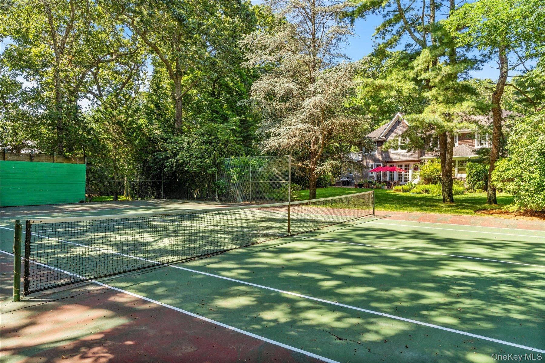53 Cedar Lane West Remsenburg, NY 11960 - Photo 11 of 38 View of tennis court with view of wooded area