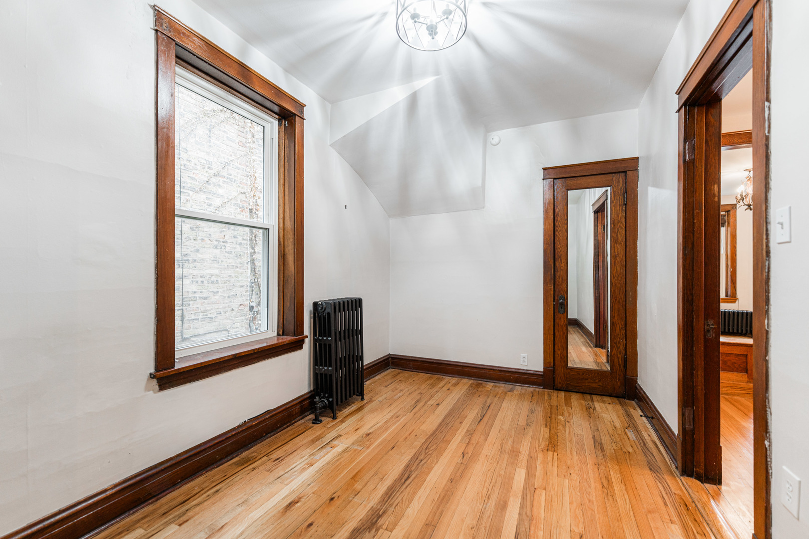 2257 North Springfield Avenue, Unit 1F Chicago, IL 60647 - Photo 16 of 27 a view of empty room with wooden floor and fan