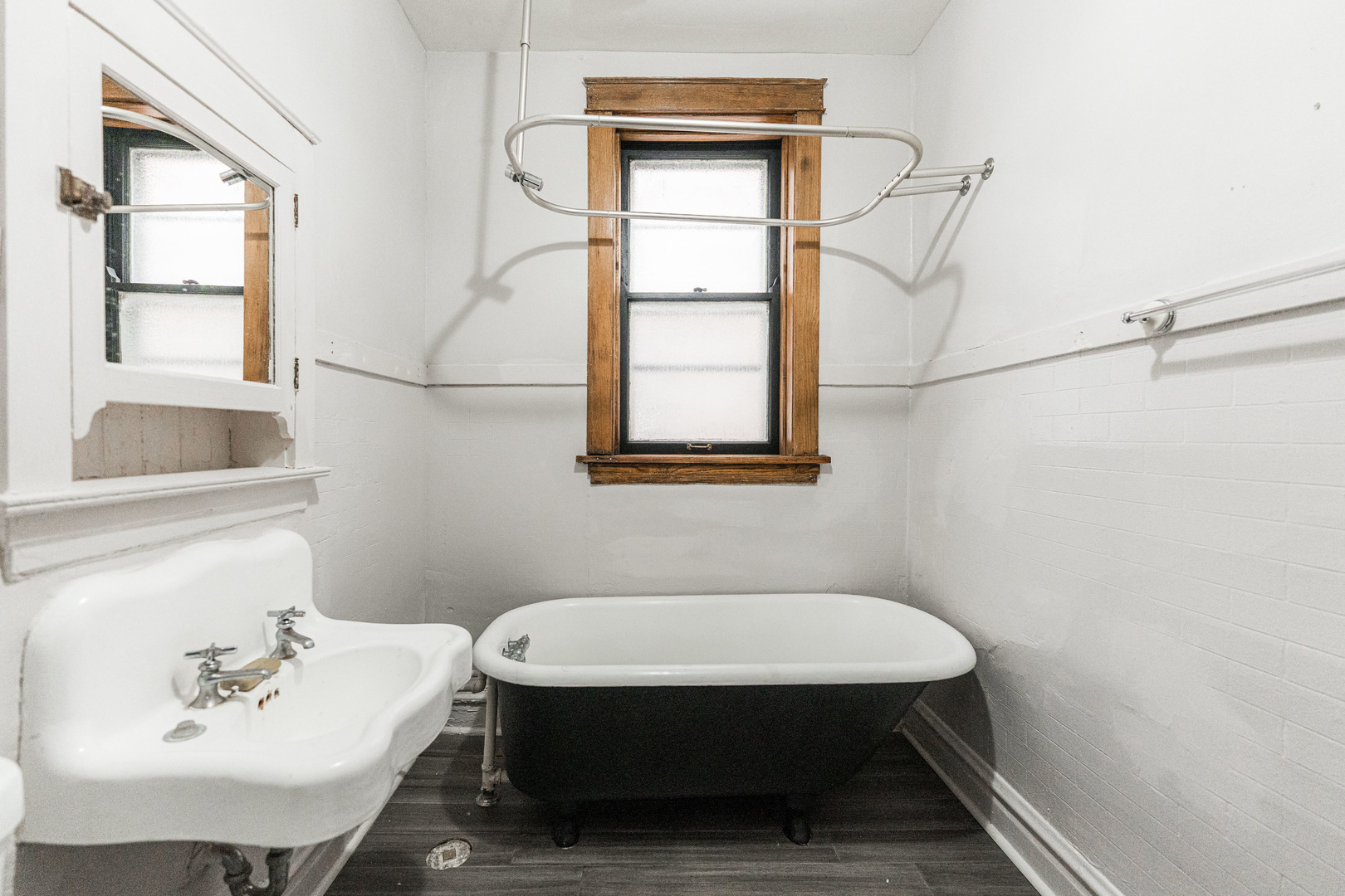 2257 North Springfield Avenue, Unit 1F Chicago, IL 60647 - Photo 19 of 27 a bathroom with a sink a window and tub