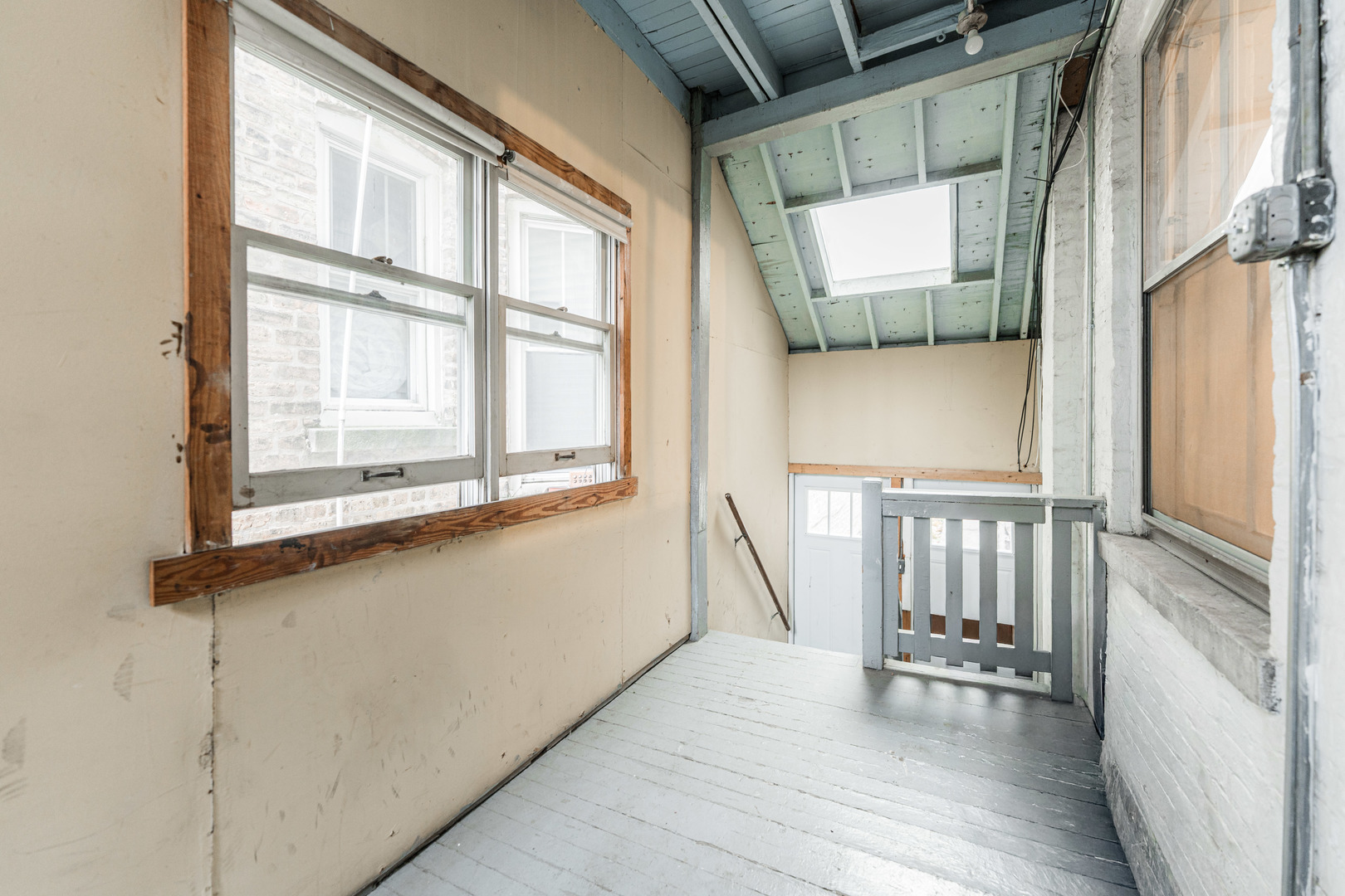 2257 North Springfield Avenue, Unit 1F Chicago, IL 60647 - Photo 21 of 27 a view of a balcony with wooden floor and furniture