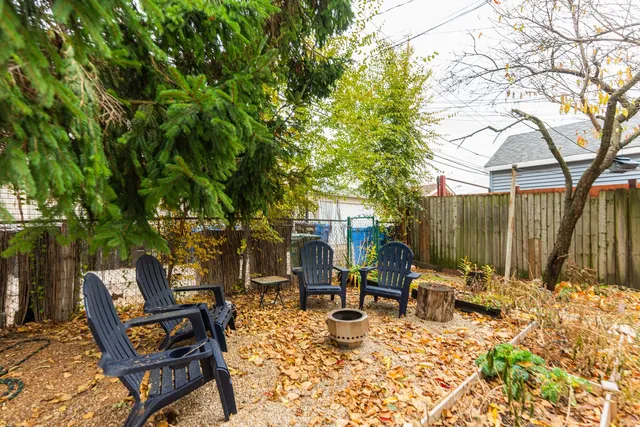 a view of a chairs and table in backyard