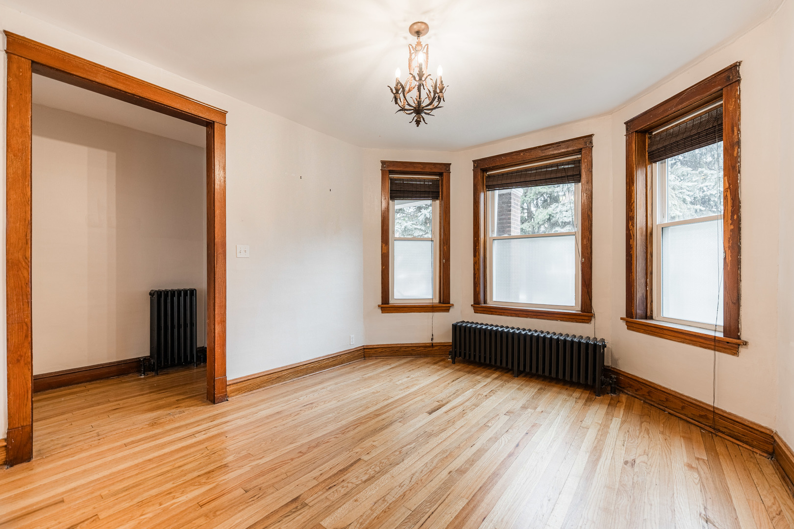 2257 North Springfield Avenue, Unit 1F Chicago, IL 60647 - Photo 3 of 27 a view of an empty room with wooden floor and a window