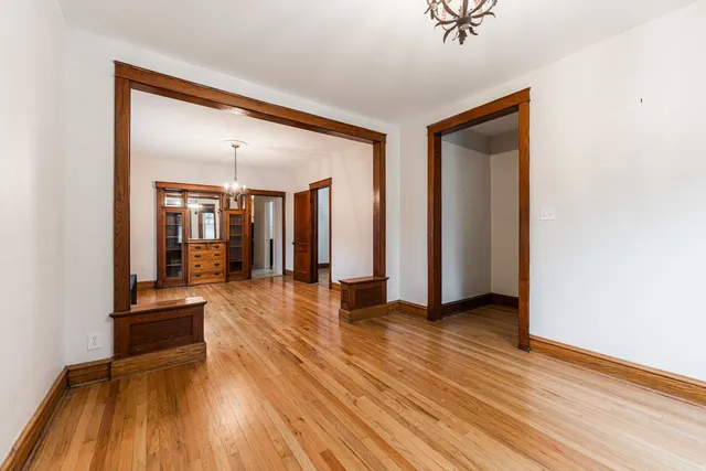 a view of a hallway with wooden floor and furniture