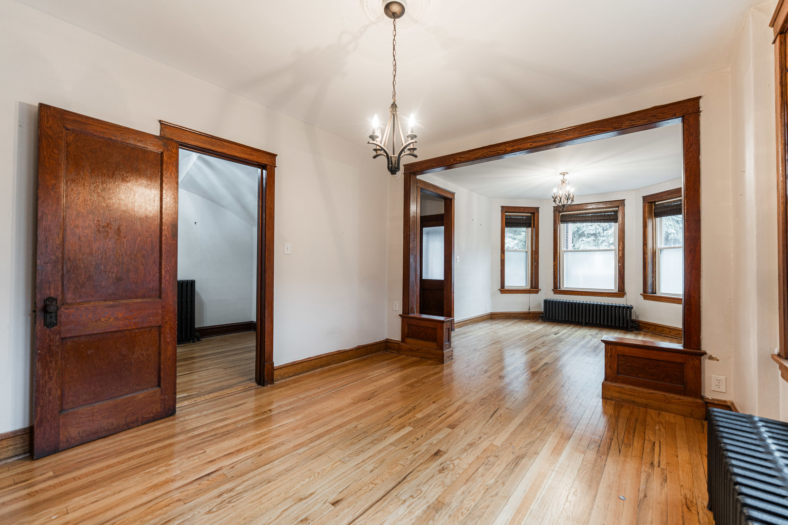 2257 North Springfield Avenue, Unit 1F Chicago, IL 60647 - Photo 8 of 27 a view of a hallway with wooden floor and a livingroom