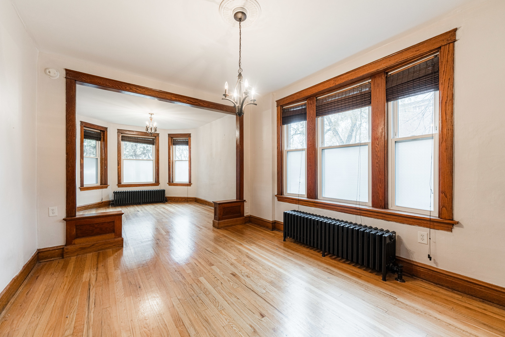 2257 North Springfield Avenue, Unit 1F Chicago, IL 60647 - Photo 9 of 27 wooden floor in an empty room with a window
