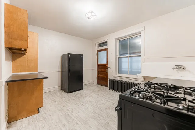 a kitchen with a stove and a refrigerator
