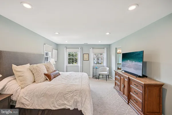 a living room with a flat screen tv a couch and a flat screen tv