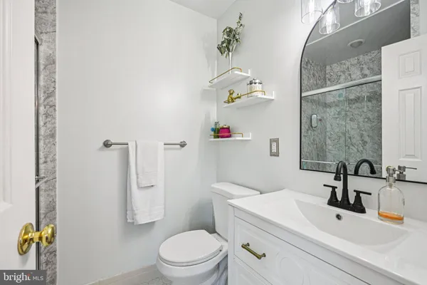 a bathroom with a sink a toilet and shower curtain