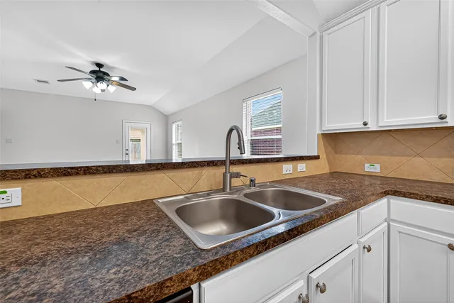 a kitchen with a sink and cabinets