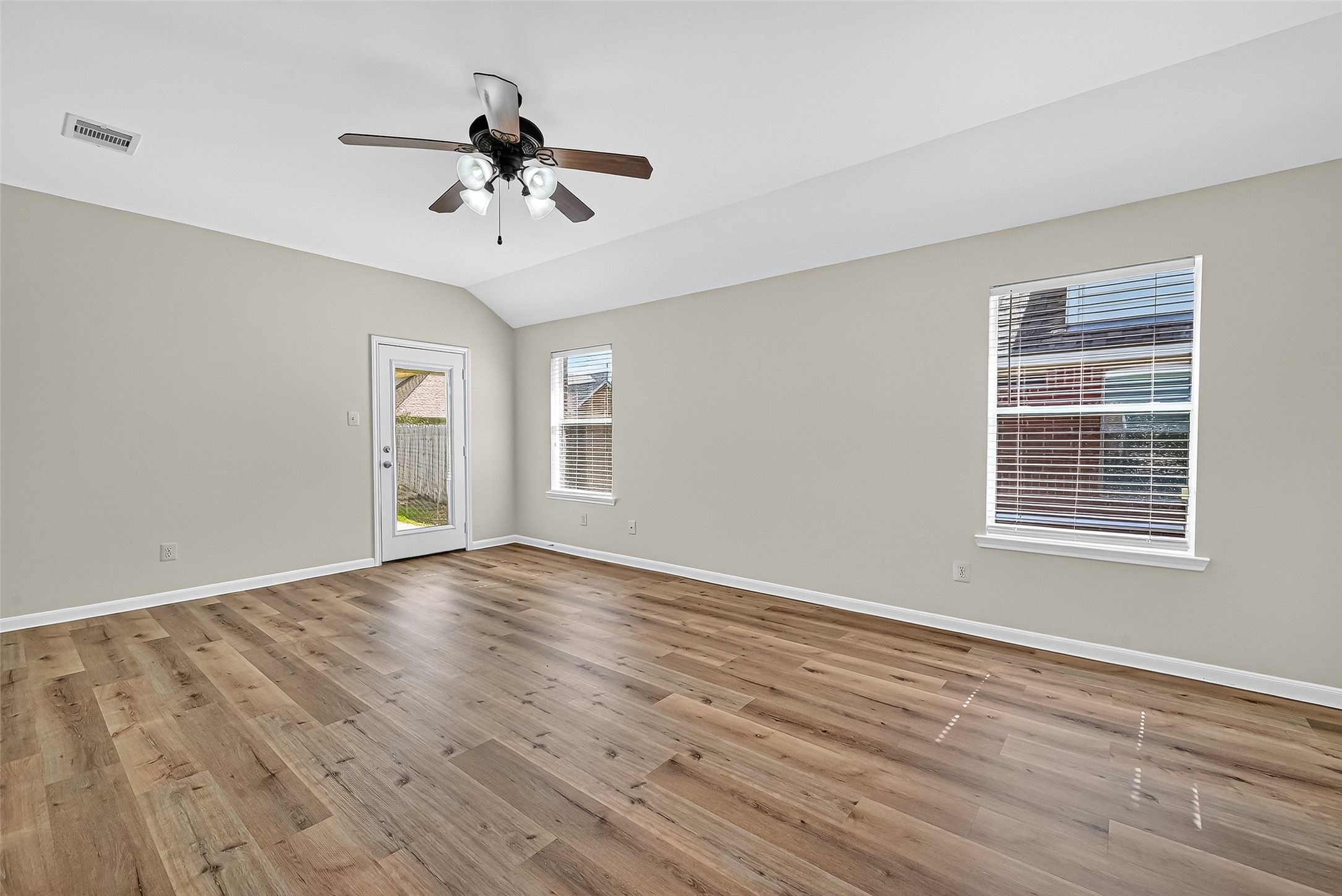 3114 Sabine Spring Lane Katy, TX 77449 - Photo 13 of 34 a view of an empty room with wooden floor and a window